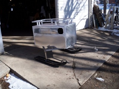 24 wide 22 tall 40 long, ss frame spring is in tongue and it has a swivel hitch, height is varied, depends on snowmobile hitch height, while you are sitting on it.